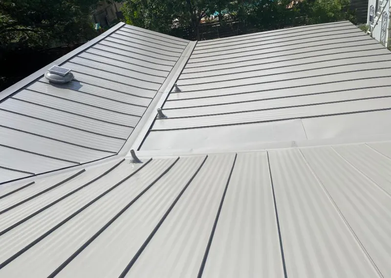 Solar attic fan installed on a metal roof for Roof Ventilation in Woodward